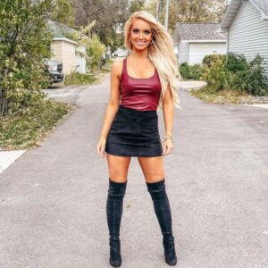Holly Jo Anne White in knee high boots and a leather skirt
